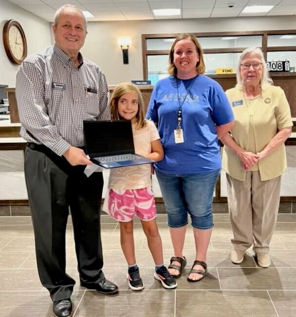 For the recent Alton School Back to School Fair, Alton Bank provided two Chromebooks to be given in a drawing at the end of the fair, one for a high school student and one for an elementary student. The elementary winner of the Chromebook is Alaina Stroh, center. Presenting her with her prize are bank President Randall G. Combs, left, and Vice President Barbara Simpson. Alaina is the daughter of Misty Hitch.
