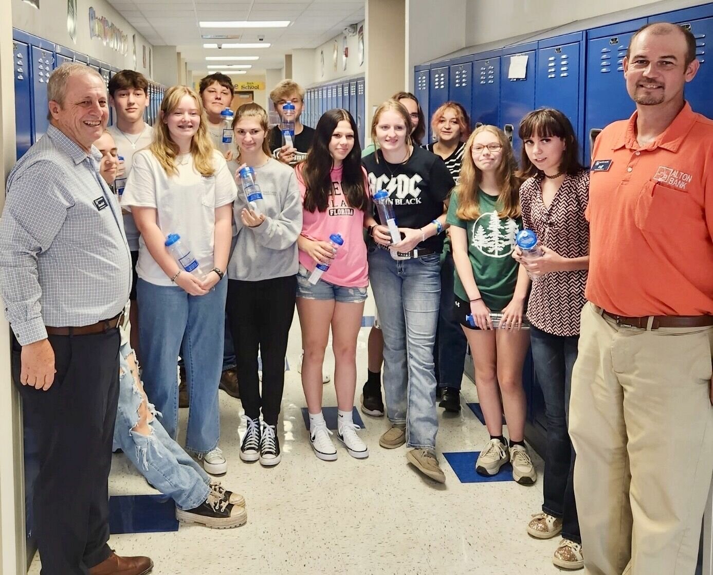 Alton Bank President Randall G. Combs, left, and loan officer Jeffery Roberts recently delivered water bottles to Koshkonong High School students and faculty.