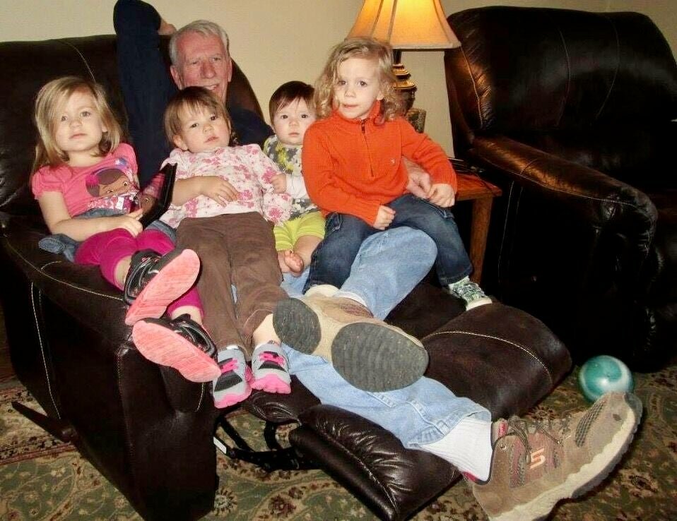 Wes Parks reclines with grandchildren Sage and Orion DeWitt, and Elizabeth and Norah Alsup.