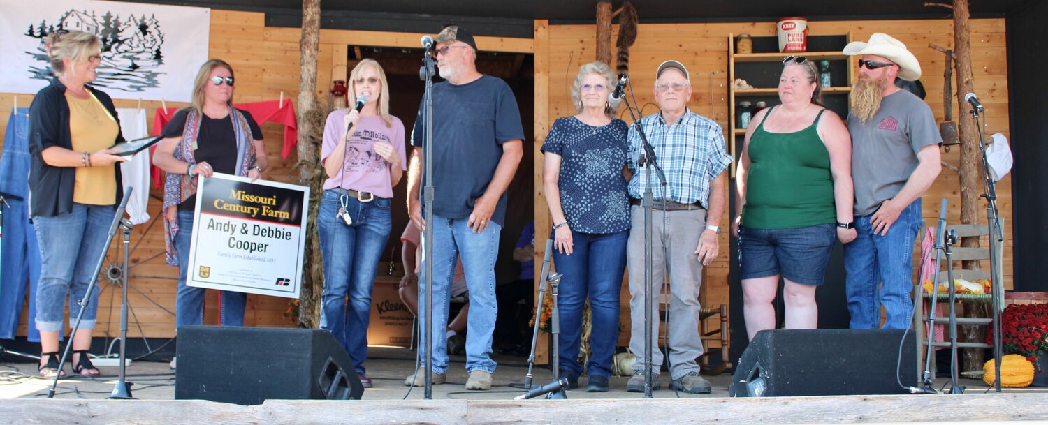 The University of Missouri Extension Century Farm belonging to Andy and Debbie Cooper of Ozark County was recognized by Extension representatives Callie Clayton and Alicia Winrod Saturday at Hootin' and Hollarin'. From left: Clayton, Winrod, the Coopers, and extended family Donna and John Epley and Amy and Jason Cooper.