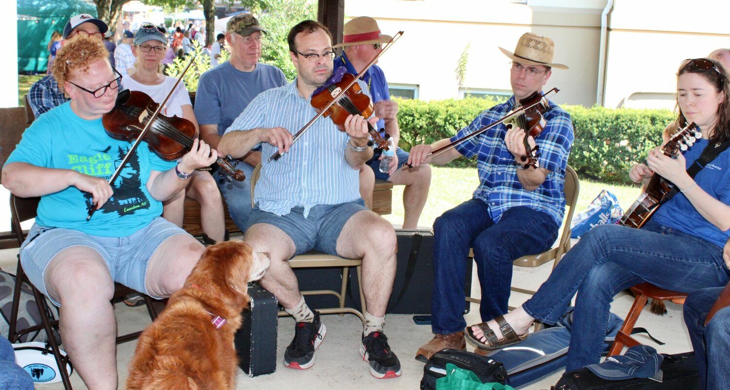 This picking circle under the gazebo on court square caught the ear and the devoted attention of at least one hound dog.