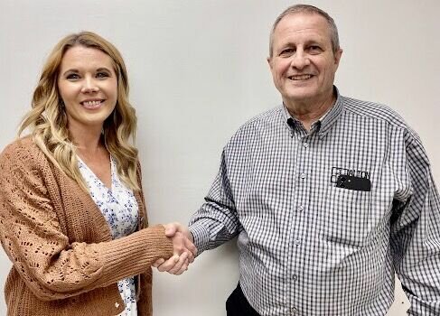 Angie Kinder, left, is congratulated on her hire as Head Start director by Ozark Action Board President Randall Combs during the agency’s meeting on Tuesday.