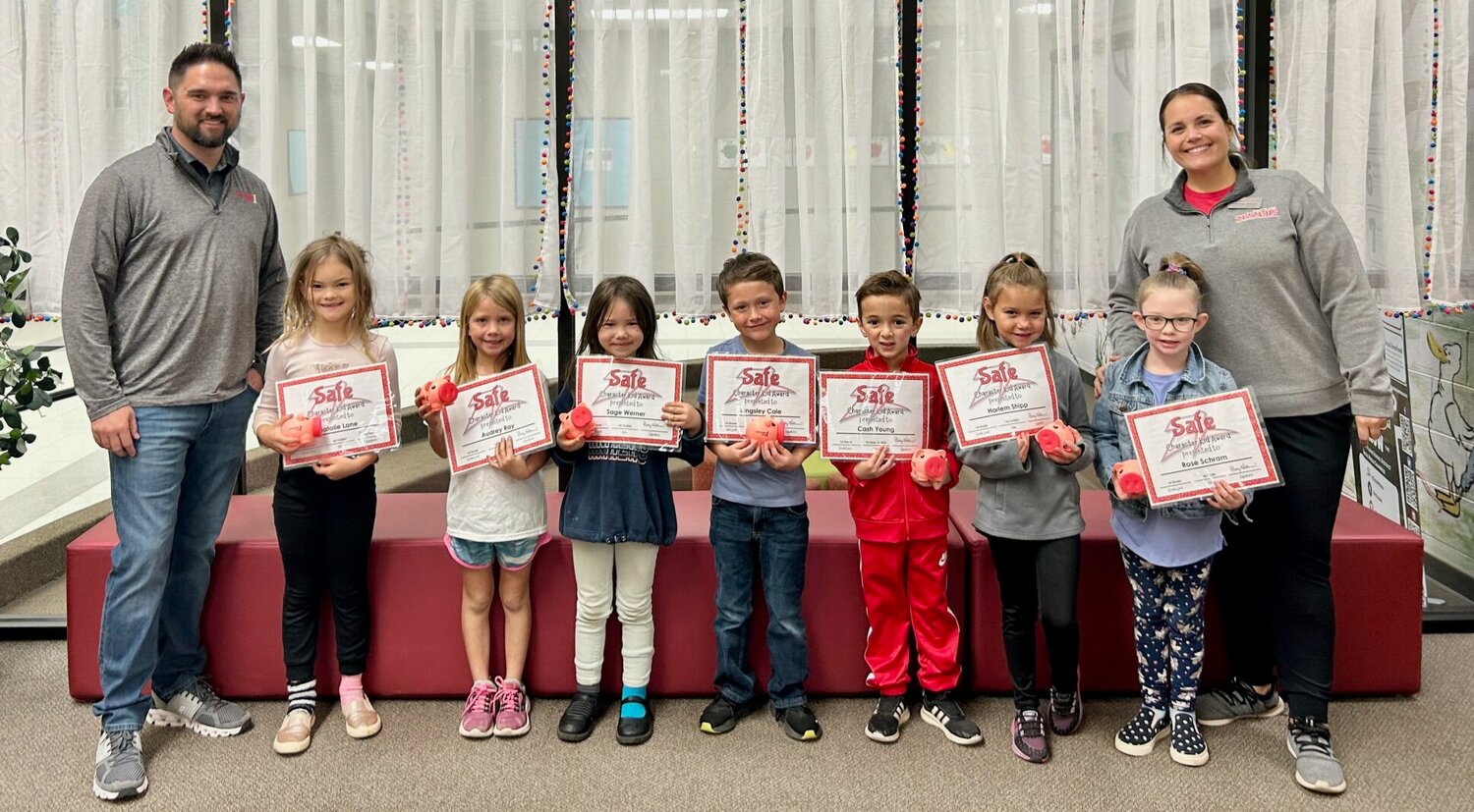Officials with West Plains R-7 School District and sponsor Community First Banking Company congratulate West Plains Elementary first grade “Safe Character" kids of the month. From left: Community First representative Daniel McKinney; students Natalie Lane, Audrey Ray, Sage Werner, Kingsley Cale, Cash Young, Harlem Shipp and Rose Schram; and Assistant Principal Virginia Uphaus.