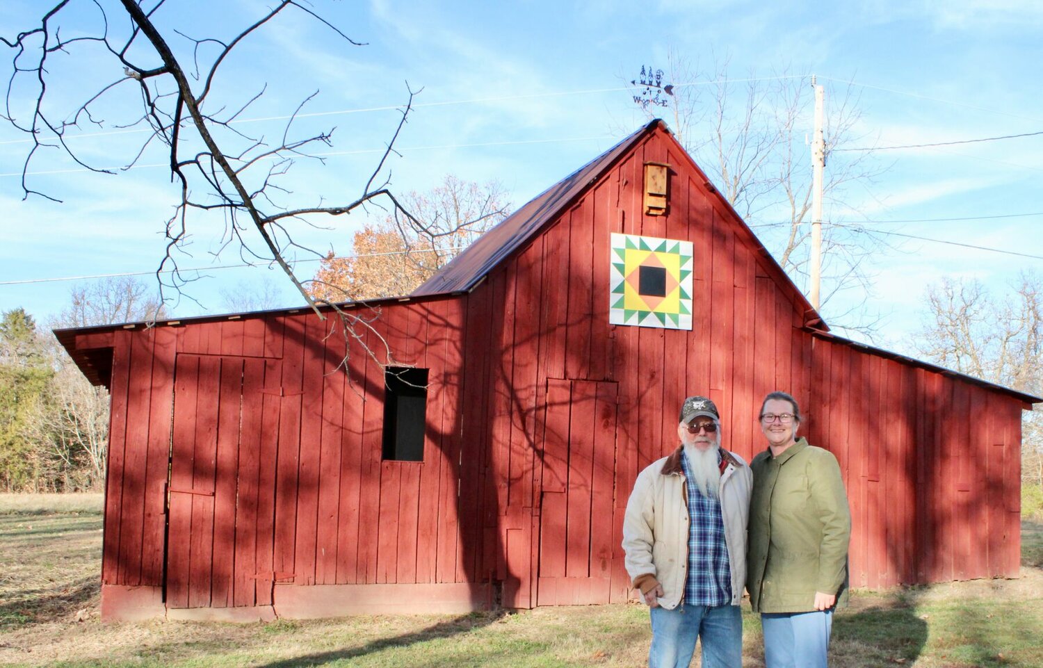 James and Jessica Brimsberry pose in front of barn on the 3-acre property they own near the corner of Gleghorn Street and Christopher Drive just inside West Plains city limits. James is retired and Jessica works from home with a company based in Green Bay, Wisc. Jessica painted the sunflower barn quilt hanging on the side, and the two have been busy renovating and restoring the property and its outbuildings.