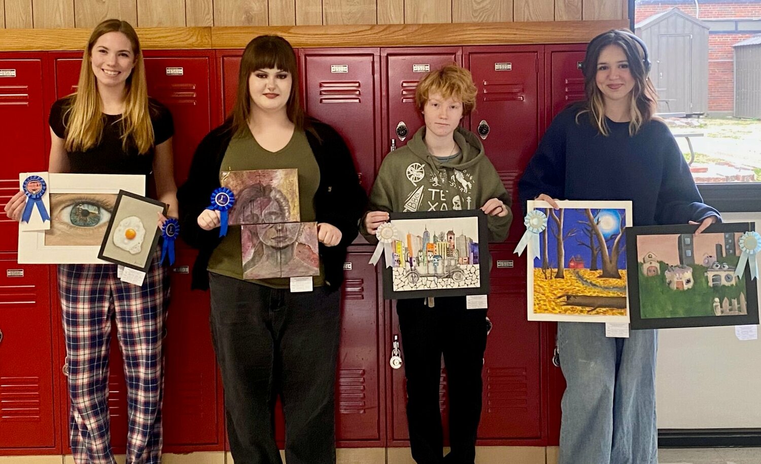 West Plains High School students entering works into the Dec. 2 High School Invitational art show hosted by the Willow Springs arts council, from left: Emily Ritter with her Best of Show colored pencil drawing of an eye and "Sunny Side Up," which took first place in the Colored Pencil category; Brooklynn Smith with her piece, "Frankie Friends," which took first place in Painting; Abigail Price with "Vintage in the City," which took third in Mixed Media; and Alyssa Heller, with two honorable mentions, a painting called "Growing Old," and a mixed-media landscape.